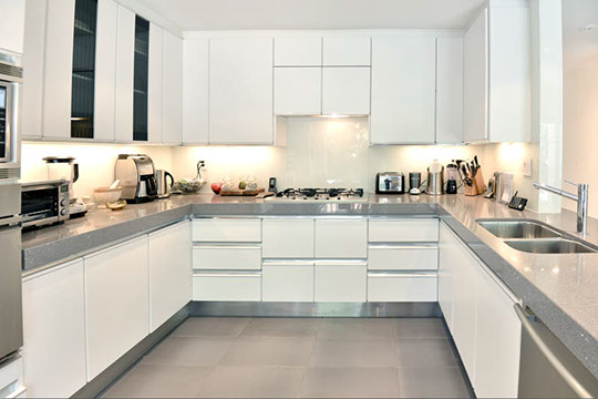 gleaming white kitchen cooking area 