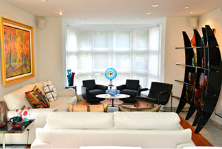 living room window with chairs and art pieces