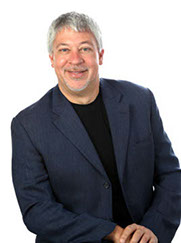 portrait of a man wearing a blue jacket