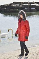 Model in red leather coat with hood up
