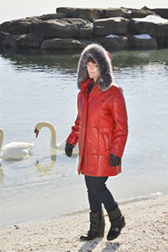 Model in red leather coat with hood up