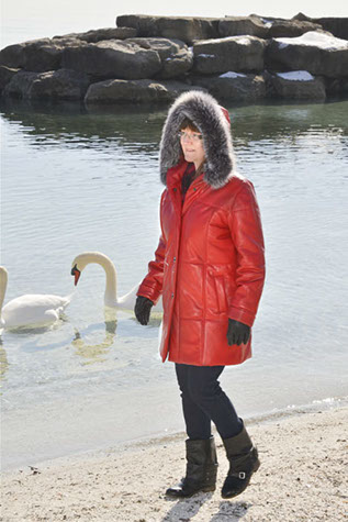 Model in red leather coat with hood up