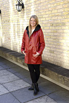 model wearing red leather coat outside